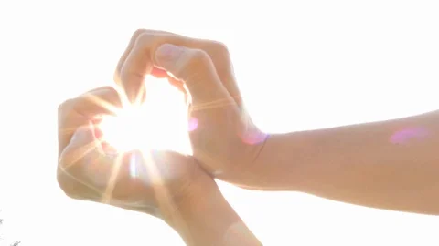 Heart shape made of hands, sun beams, brightness, love Video stock 89562140