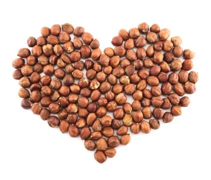 Heart shape made of hazelnuts isolated Stock Photos