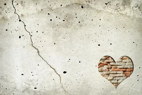 Heart shape made of old bricks on concrete wall. Valentines day background Stock Photos