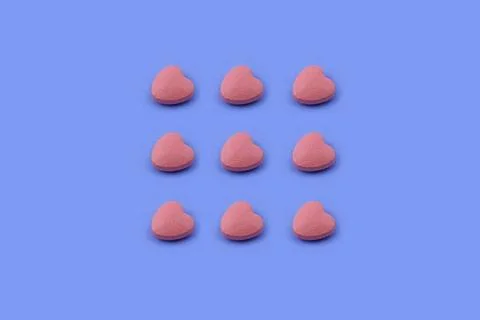 Heart shape Pharmaceutical medicine tablet on a blue background, Medicine ... Stock Photos