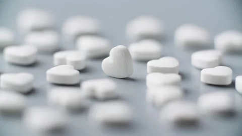 Heart shape pills rotating on table. Pharmaceutical market, medication treatment Stock-Footage 304287245