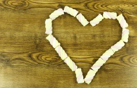 The heart shape pink marshmallows on background. Stock Photos