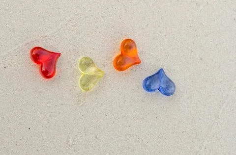 Heart shape plastics on the sand Stock Photos