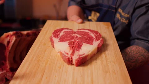 Heart shape raw fresh meat beef ribeye steak. Video stock 295262528