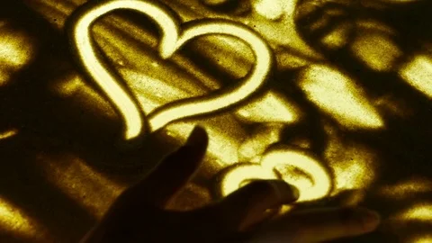 Heart shape from the sand by hand drawing Stock Footage 80281646