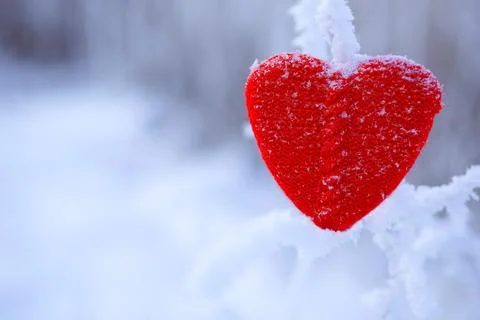 Heart shape on a snowy background Stock Photos