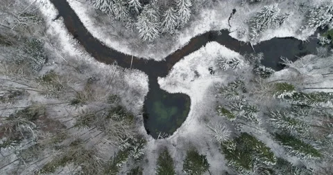 Heart shape spring water lake in snowy nordic winnter forest aerial descend Video stock 149582719
