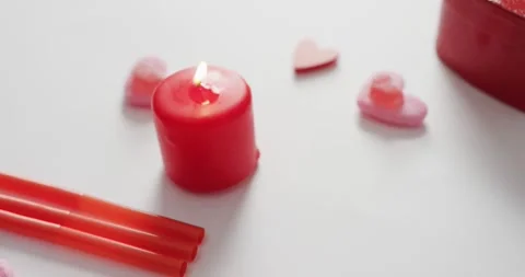 Heart shape sweets and candles on pink background at valentine's day Vídeo Stock 337159027