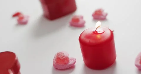 Heart shape sweets and candles on pink background at valentine's day Vídeo Stock 343364702