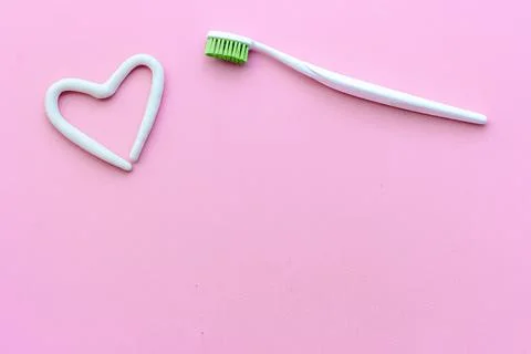Heart shape of toothpaste with toothbrush, top view. Oral care and hygiene Stock Photos
