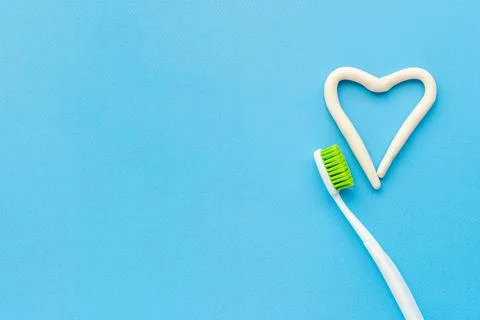 Heart shape of toothpaste with toothbrush, top view. Oral care and hygiene Stock Photos