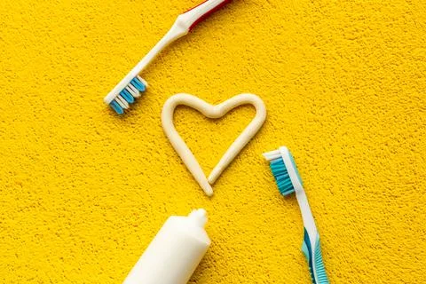 Heart shape of toothpaste with toothbrush, top view. Oral care and hygiene Stock Photos