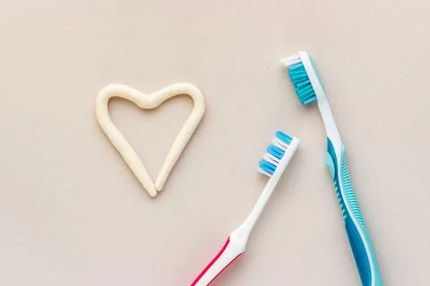 Heart shape of toothpaste with toothbrush, top view. Oral care and hygiene Stock Photos