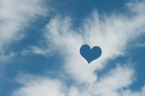 A heart shape in the white clouds Stock Photos