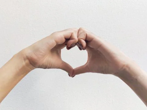 Heart shape by woman's hands Stock Photos