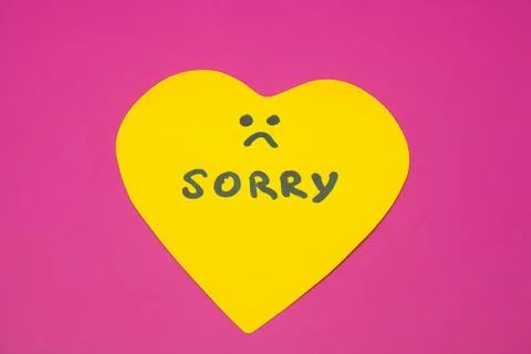 Heart-shaped apology note on a vibrant pink background Stock Photos