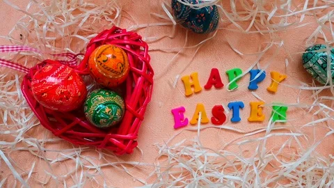Heart-shaped basket with easter eggs and "Happy Easter" words Stock Footage 103852109