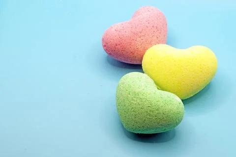 Heart-shaped bath bombs in close-up on a blue background Stock Photos