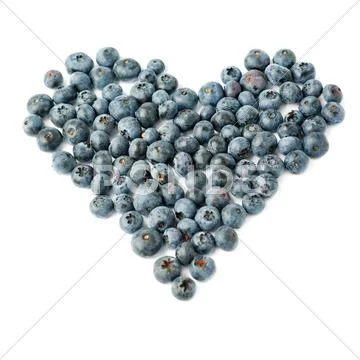Heart shaped Bilberry or blueberry composition over isolated white background Stock Photos