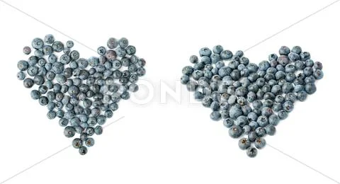 Heart shaped Bilberry or blueberry composition over isolated white background Stock Photos