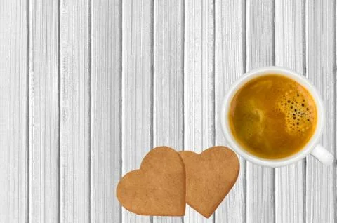 Heart shaped biscuits and cup of coffee on white wooden background, top view Fotos Stock