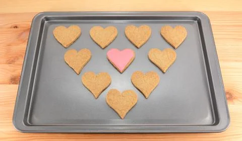 Heart-shaped biscuits on a cookie sheet Stock Photos
