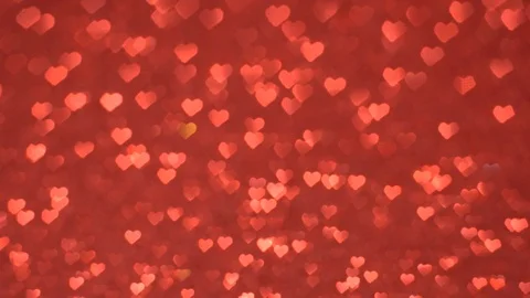 Heart-shaped bokeh move cyclically on a red background. Vídeo Stock 122815883