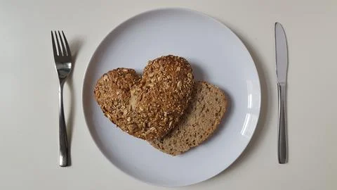 Heart shaped bread, top view, white background Stock Photos