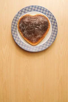 Heart shaped cake on plate with copy space Stock Photos
