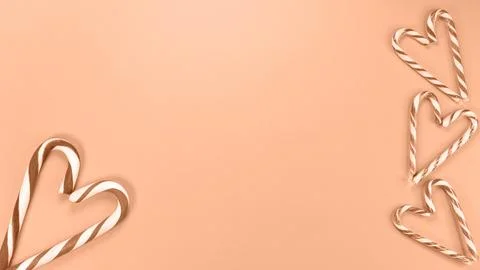 Heart shaped with Candy cane sweets. Image toned in Peach Fuzz color of the year Stock Photos