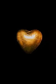 Heart shaped candy golden wrapper Stock Photos