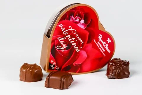 Heart-shaped chocolate box with assorted candies for Valentines Day celebration Stock Photos