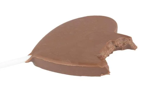 Heart-shaped chocolate on a stick bite isolated on white background Stock Photos