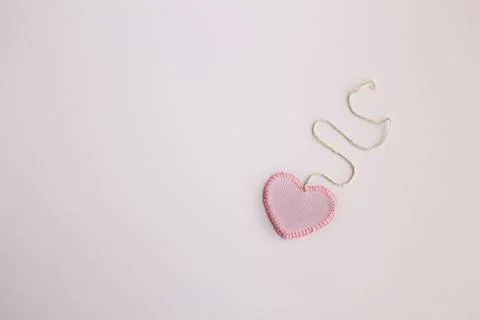 Heart-shaped cloth patch on white background Stock Photos