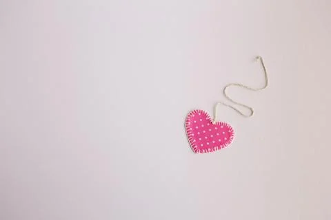Heart-shaped cloth patch on white background Stock Photos