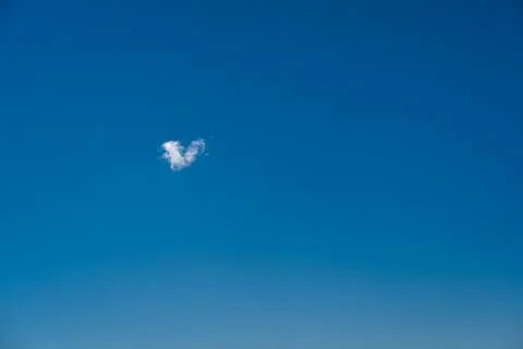 Heart shaped cloud in the blue sky Stock Photos