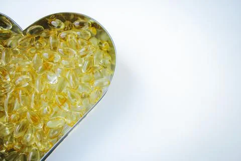 A heart shaped container filled with numerous transparent. Photos