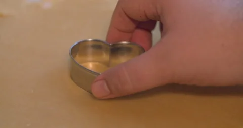 Heart Shaped Cookie Cutter Cutting into Cookie Dough Stock Footage 101051539