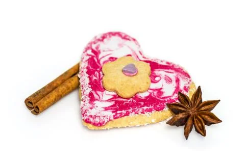 Heart shaped cookie decorated with cinnamon and star anise isolated on white Stock Photos