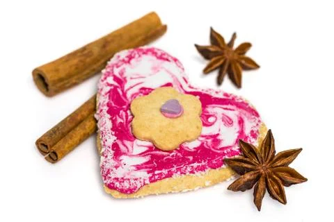Heart shaped cookie decorated with cinnamon and star anise isolated on white Stock Photos