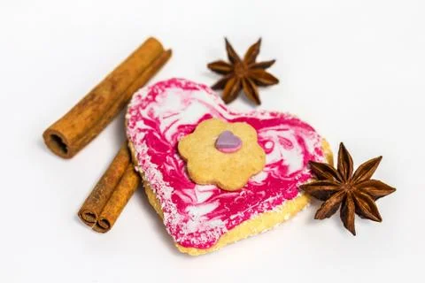 Heart shaped cookie decorated with cinnamon and star anise isolated on white Stock Photos