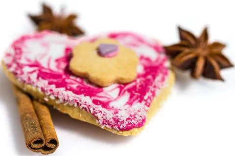Heart shaped cookie decorated with cinnamon and star anise isolated on white Stock Photos