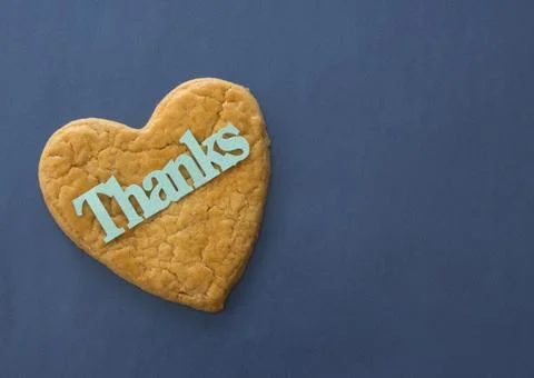 Heart-shaped cookie with "Thanks" Stock Photos