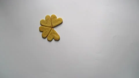 Heart shaped cookies flower pattern appears on a white background stop motion Stock Footage 152305994