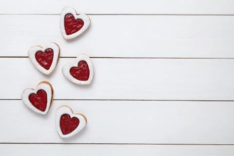 Heart shaped cookies with jam for Valentines day on white wooden background Stock Photos