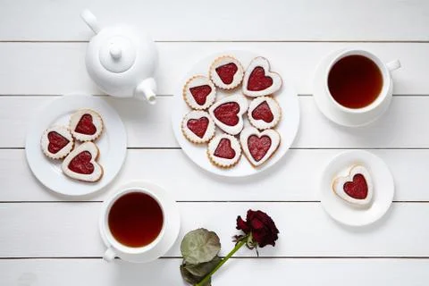 Heart shaped cookies for Valentines day with teapot, two cups of tea and rose Stock Photos