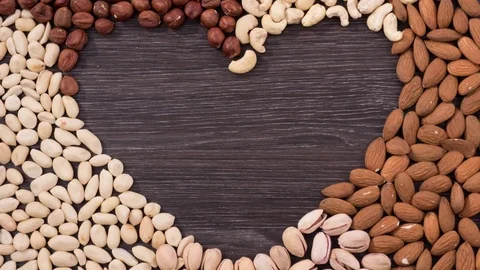 Heart-shaped frame made from nuts. Stop motion Video stock 72717056