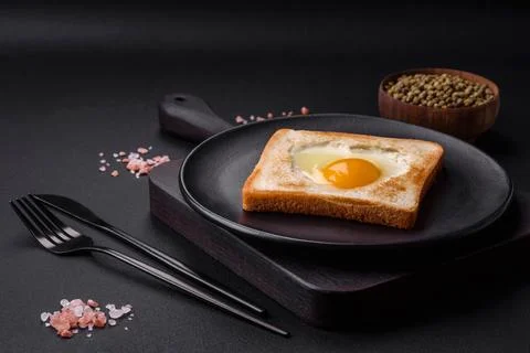 Heart shaped fried egg in bread toast with sesame seeds, flax seeds and pum.. Stock Photos