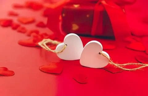 Heart-shaped gift tags with string on red background Stock Photos