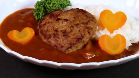 Heart-shaped hamburger curry close up, rotating Stock Footage 320328174